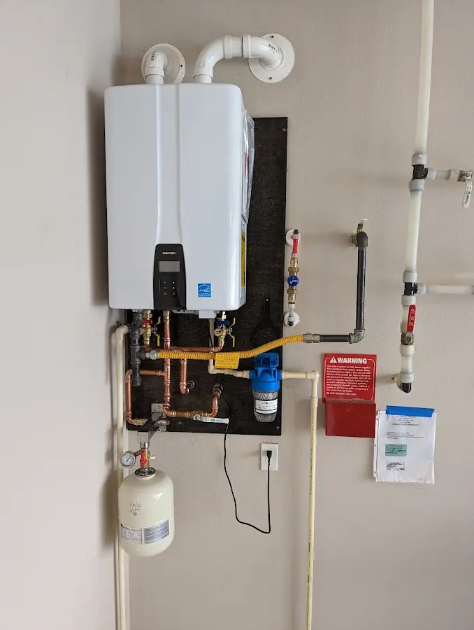 Professional plumber installing copper piping in a Michigan City home